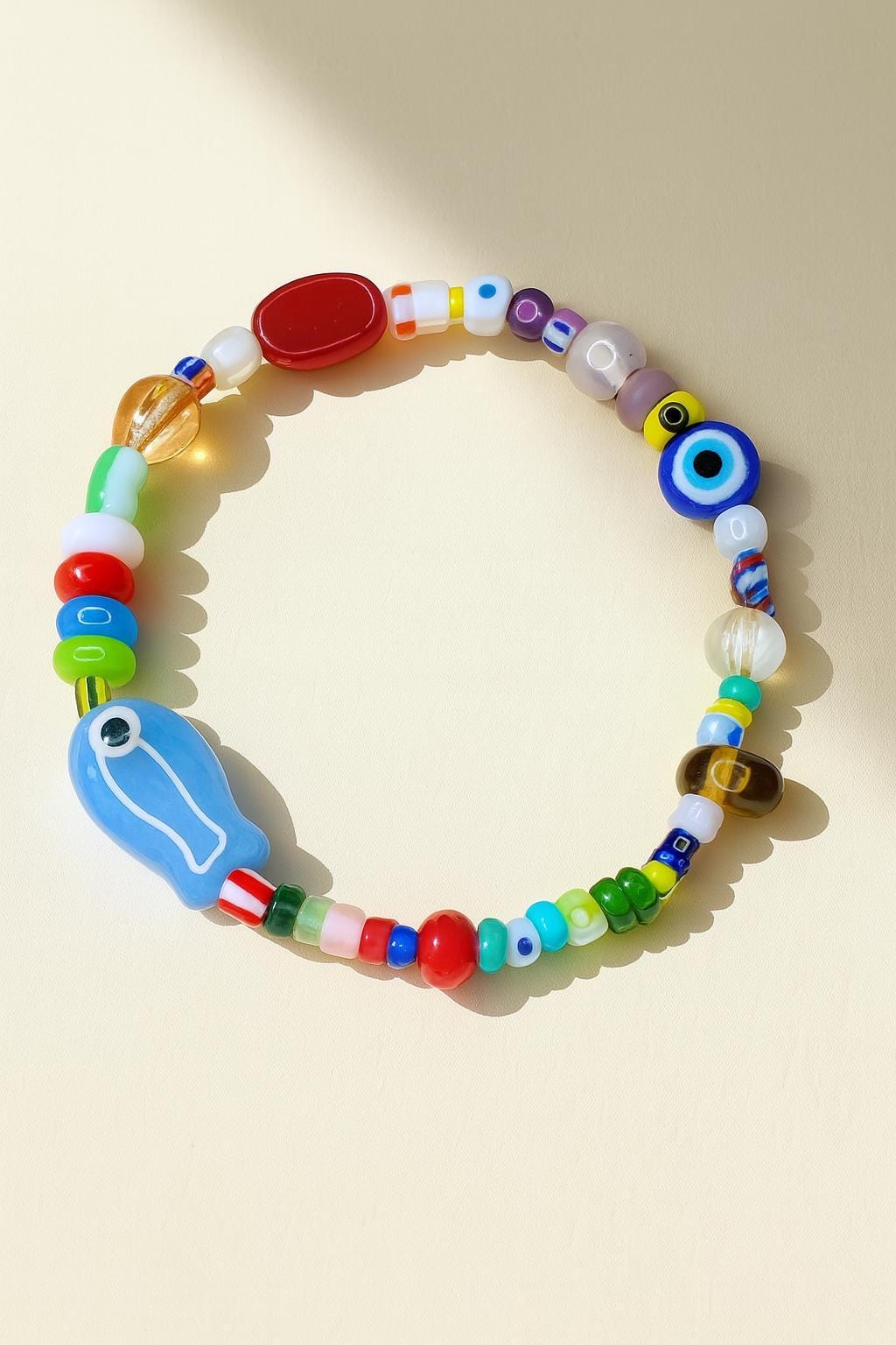 porcelain fish charm bracelet with evil eye and freshwater pearls